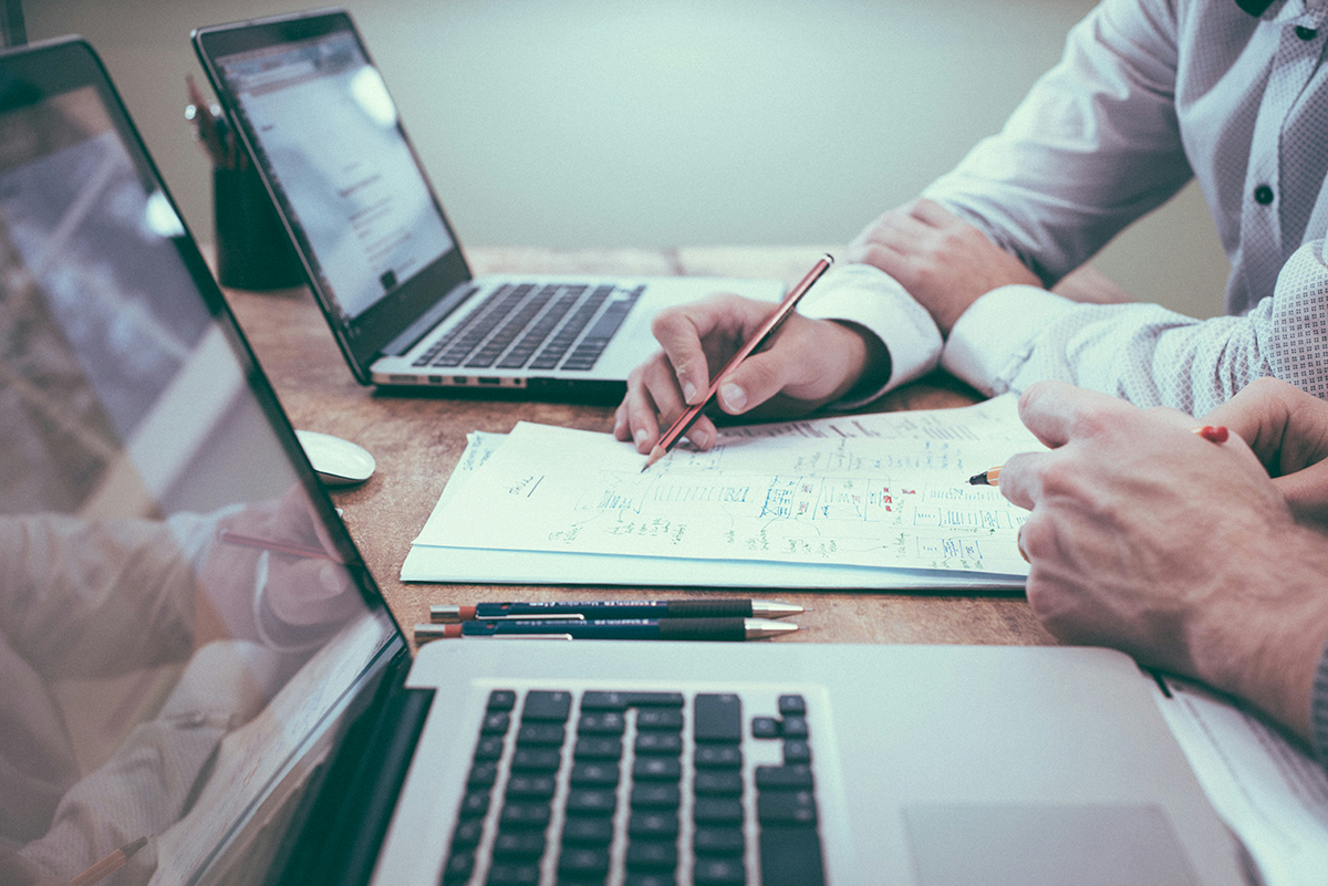 Financial planning and analysis with laptop and documents